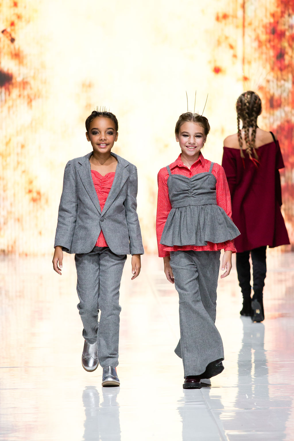 Young girl on struts the Grey Flannel blazer with matching Suit Pants and Peplum Heart Print top.