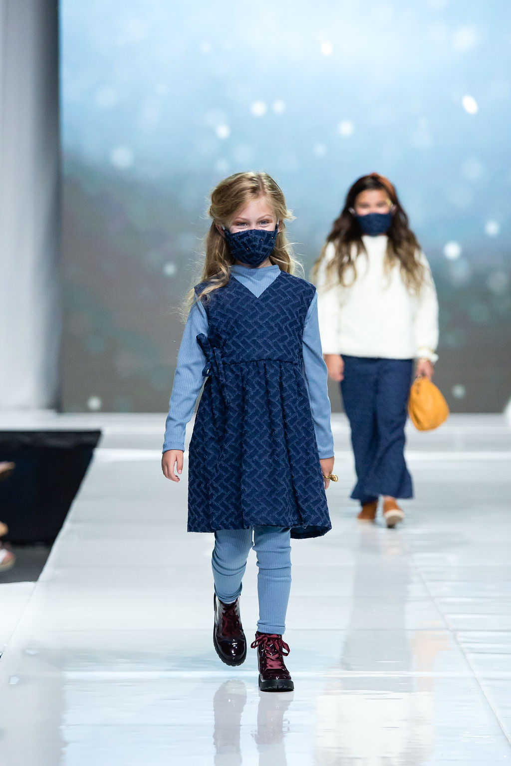 Sweet girl walks the runway in her subtle knife dress, paired with blue rib knit tunic and leggings