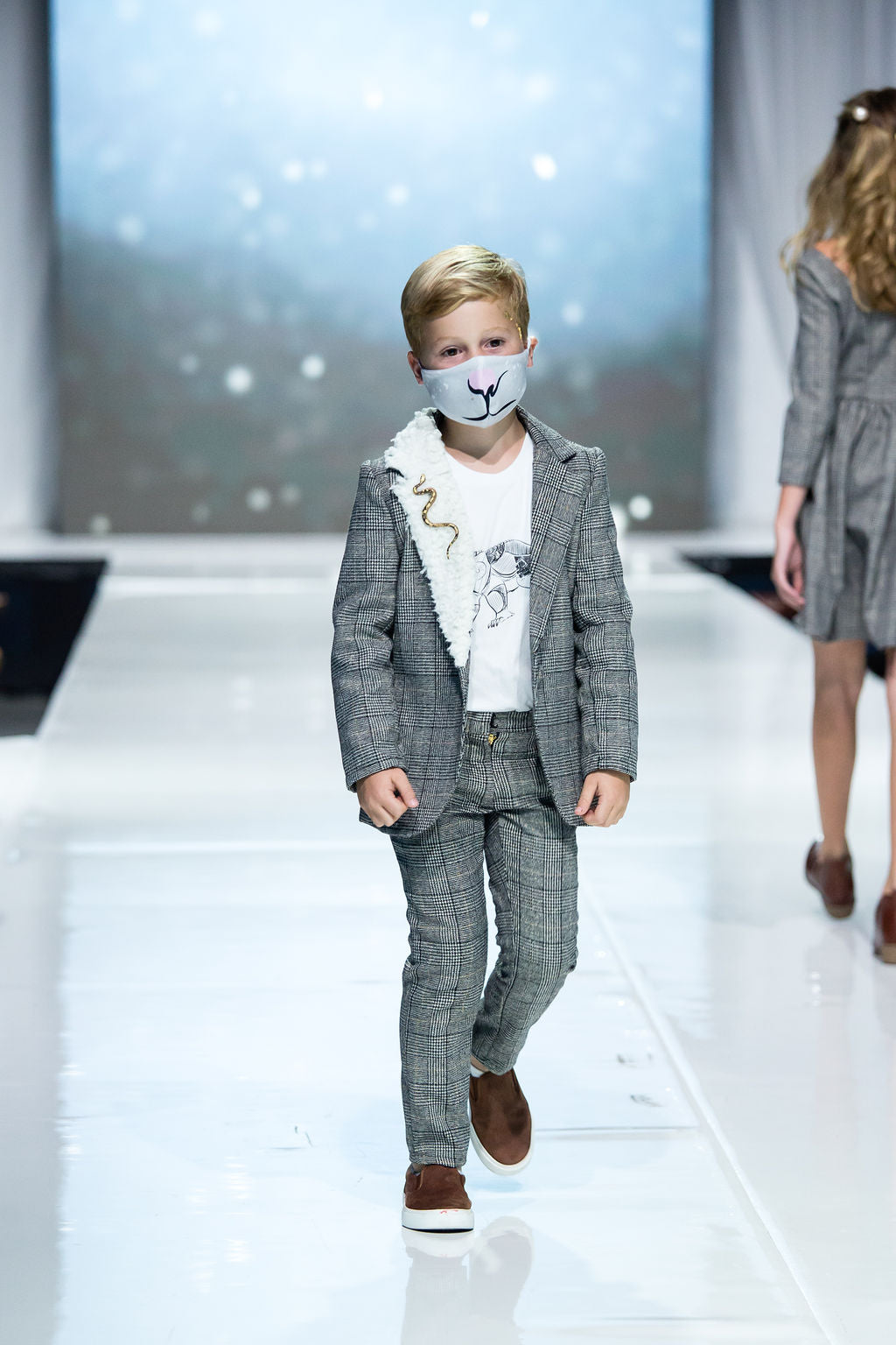 Young lad struts the runway in his Asriel Blazer, Scholars pants, and lorek shirt with matching mask