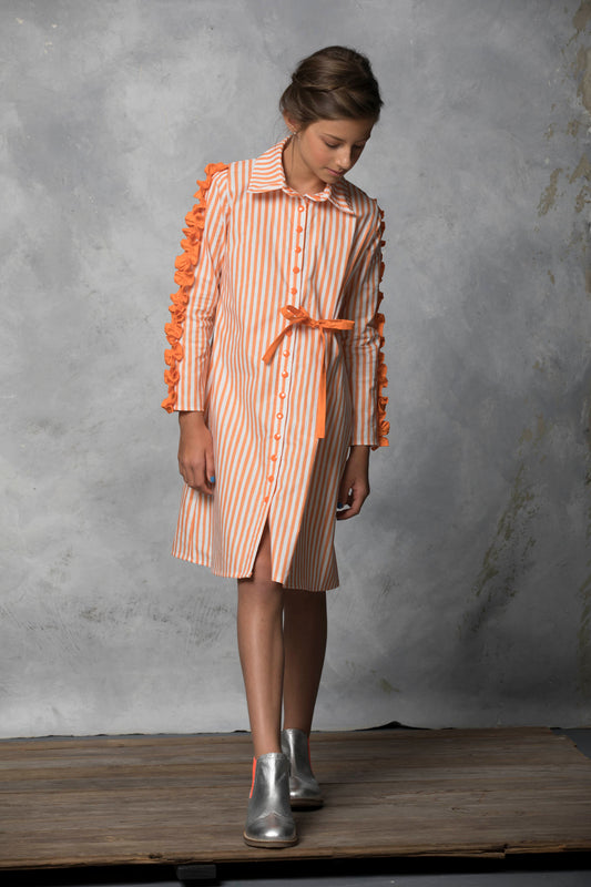 With head to the ground, this young lady poses in her orange pin stipe Saturn shirt dress