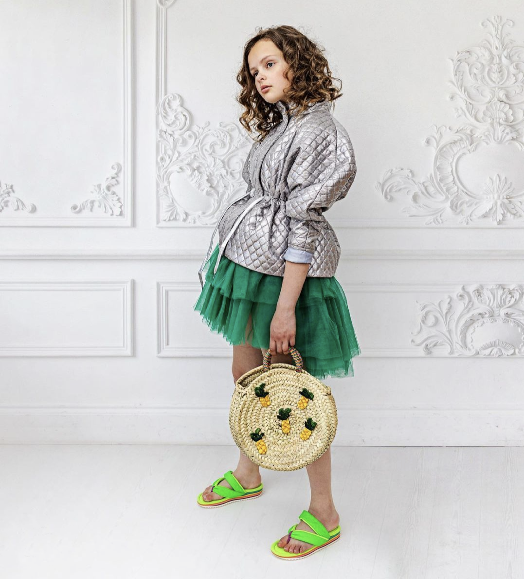 Pepper.Pics poses in her Atari Jacker with a green tiered tulle skirt, and pineapple weaved hand bag