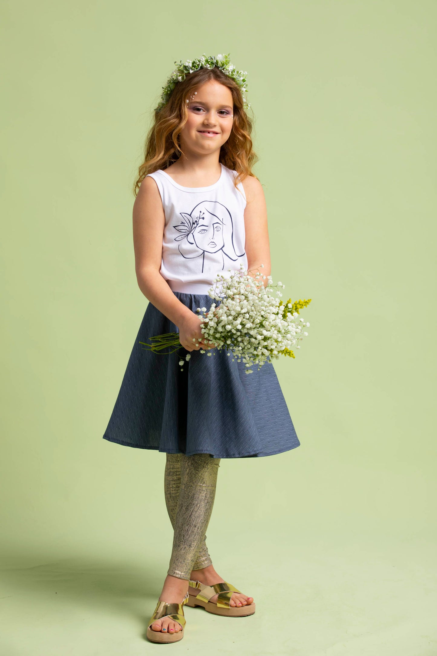 Cute young lady holds a handful of flowers while in her navy blue Mercedes Skirt and Ofelia T-Shirt