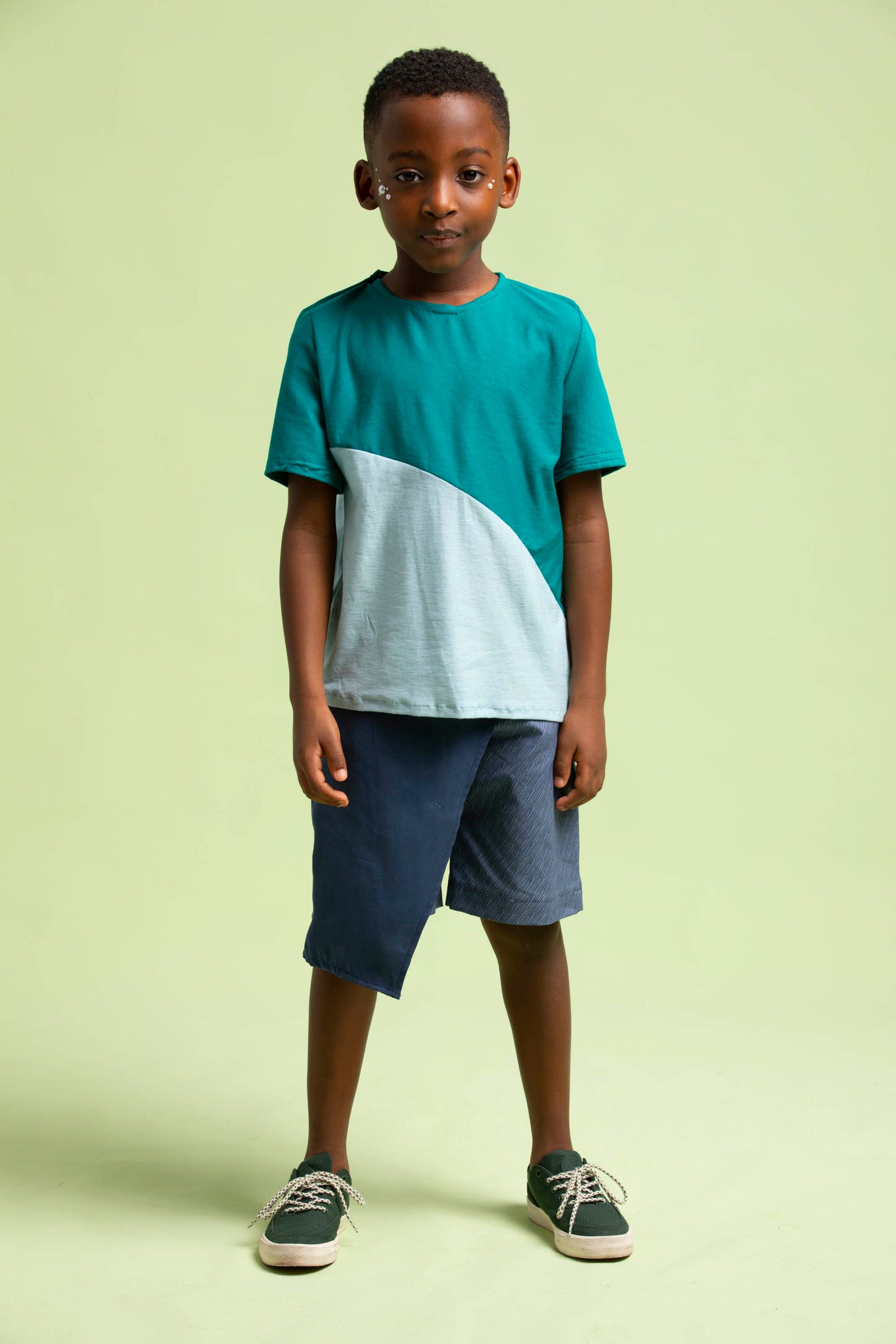Young man faces to the camera in his Maze Shorts with an asymmetrical wrap