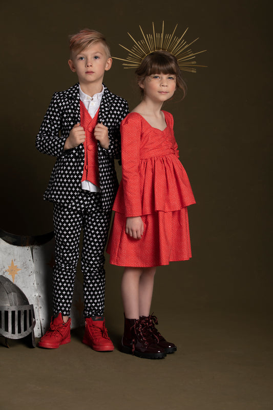 Young queen stand next to her knight sporting his red heart vest paired with the plus print suit