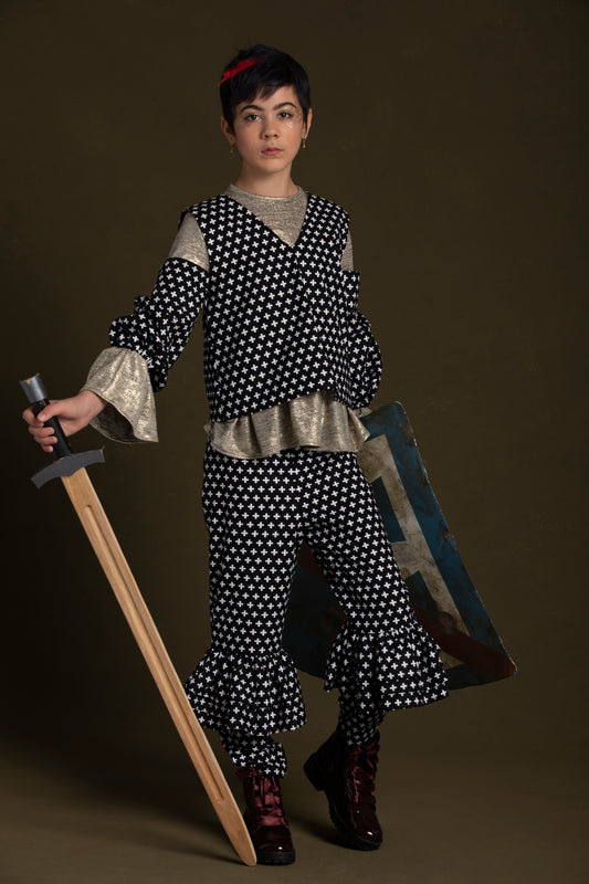 Child gracefully wields a sword and shield in the plus print off-shoulder top with ruffle knee pants