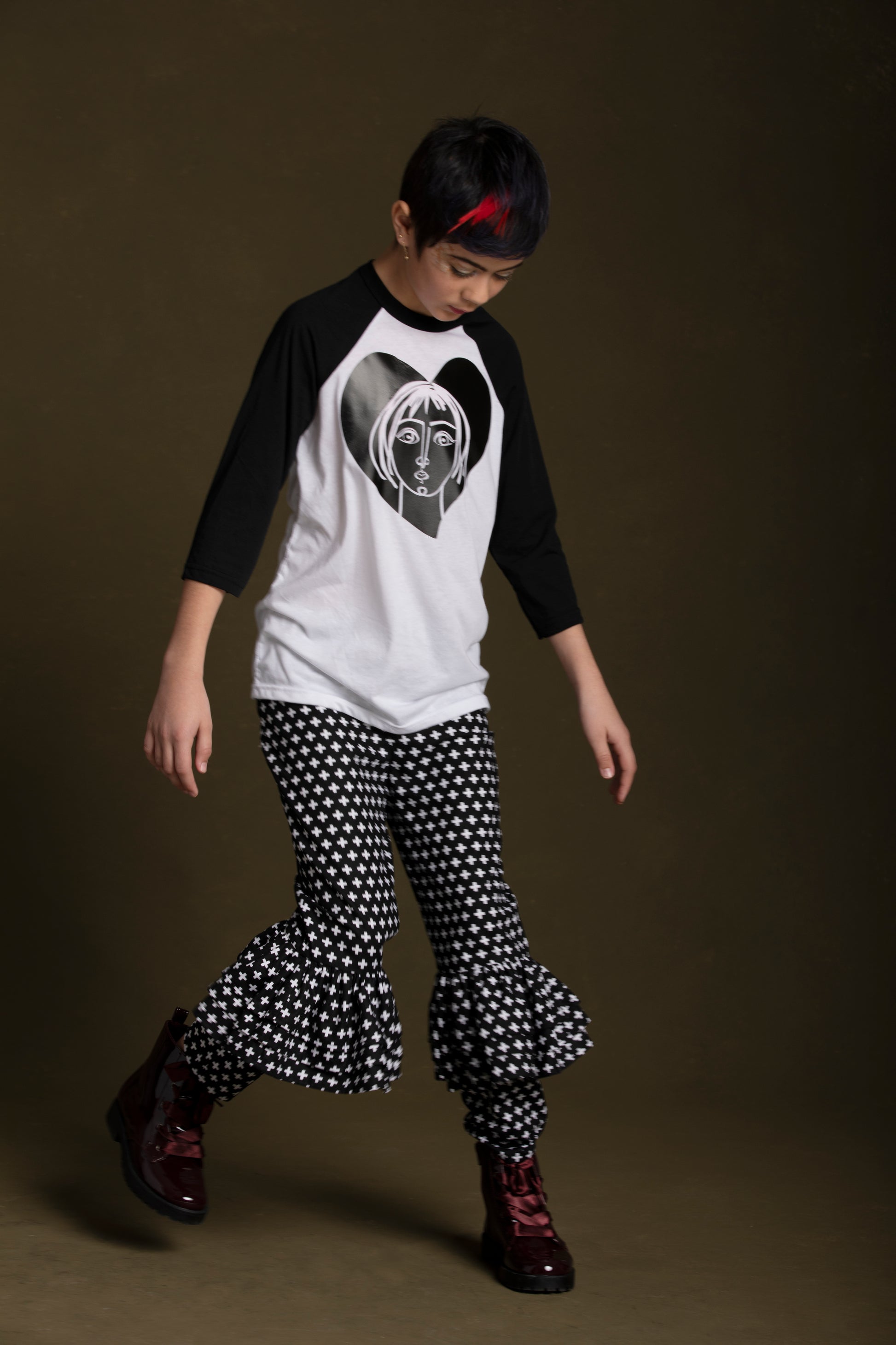 Sweet young lady wears her ruffle knee pants with the Joan T-Shirt and fashionable boots